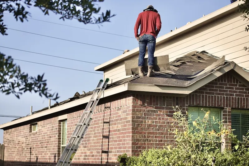 Professional roofer working on a residential roof in Rocky Acres